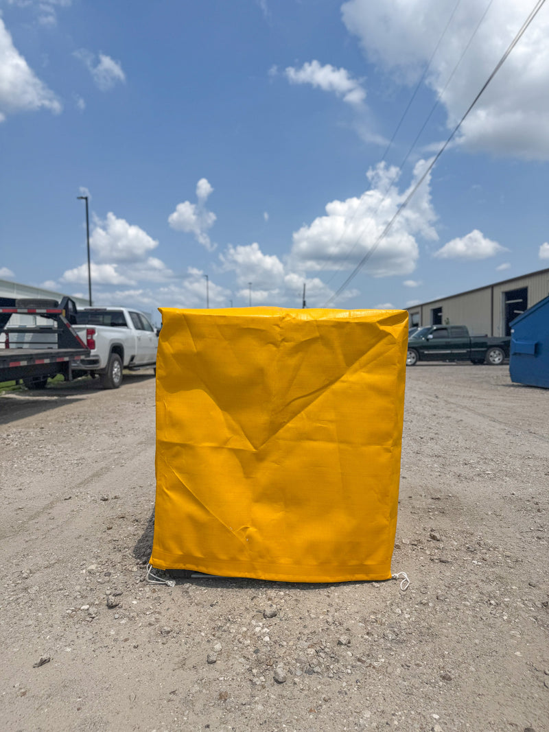 Yellow UV-Resistant Tote Cover for industrial Weather Protection in use.
