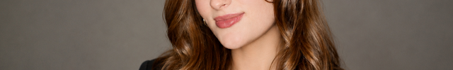 Janey Small wearing a black blazer against a gray background