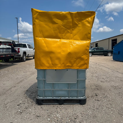 Yellow Heavy Duty Tote cover on a large blue container outdoors with a clear sky.