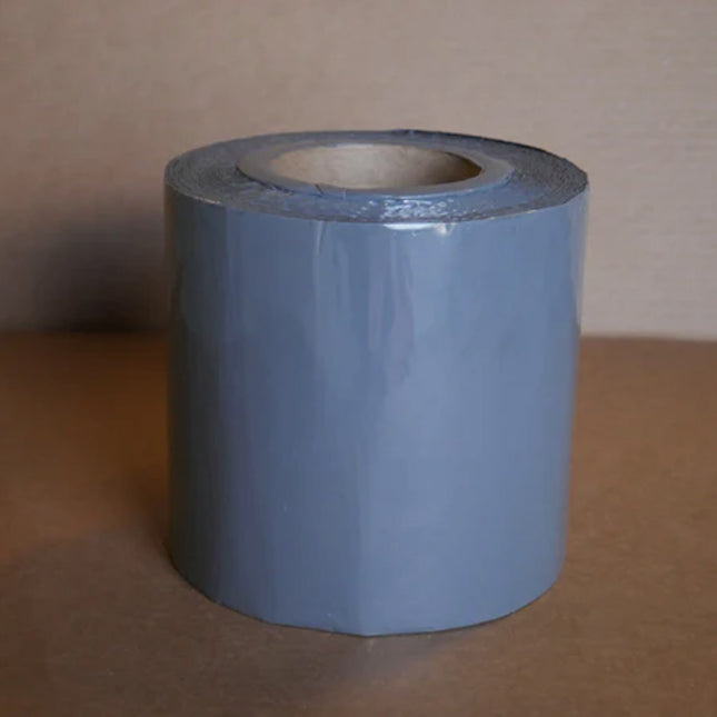 A roll of gray 6 inch berm tape 