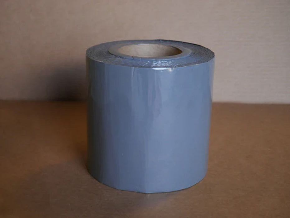 A roll of gray 6 inch berm tape 
