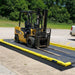 A berm pad with a ProFlex Drive Over Foam berm on top and a forklift inside the berm
