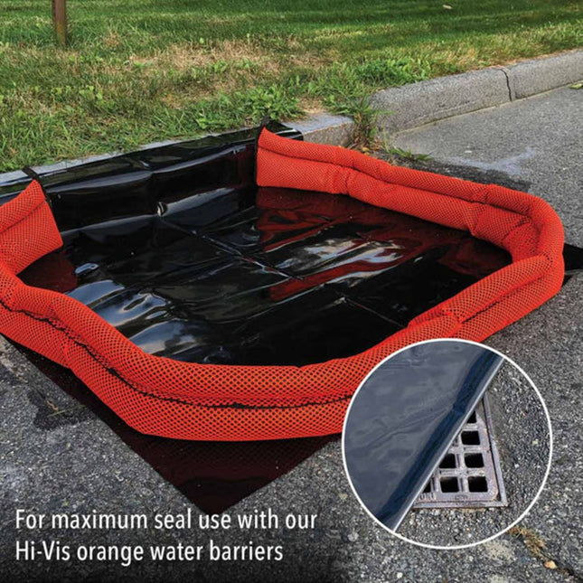 A drain seal with a black mat over drain and a high visibility orange barrier around it
