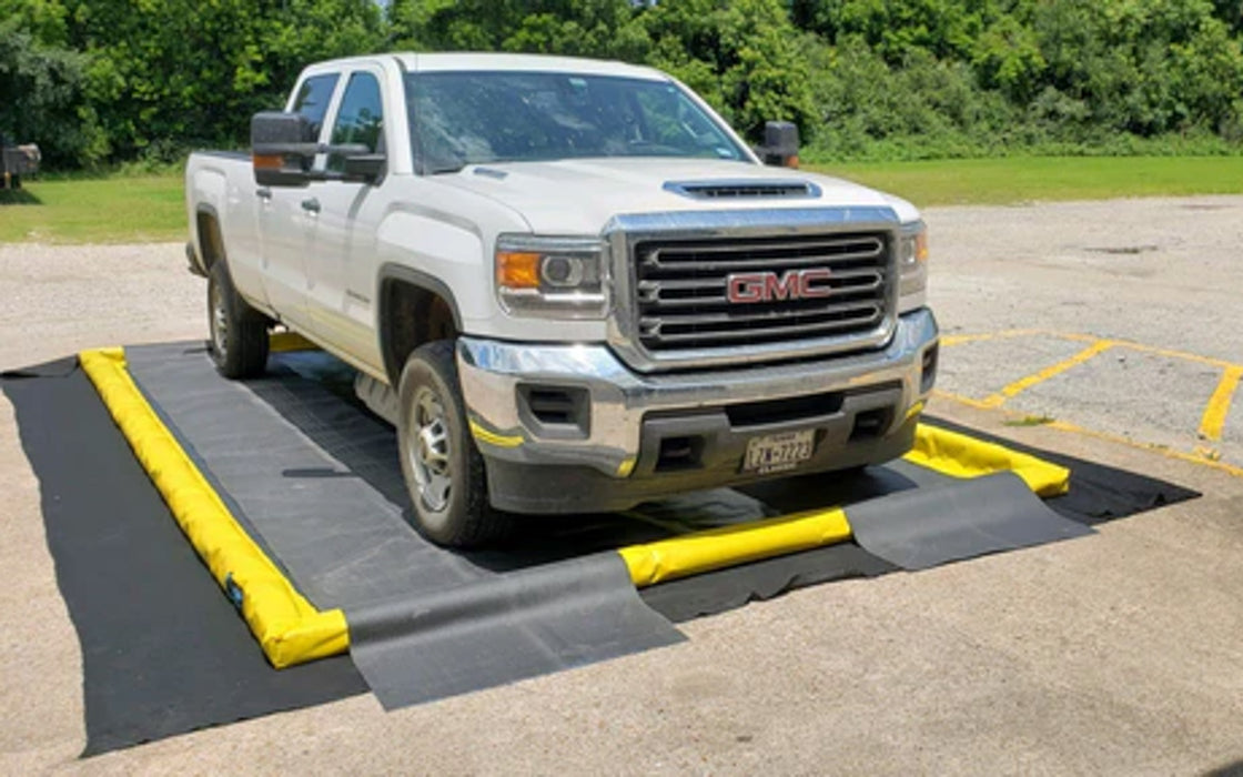 A berm pad with a ProFlex Foam Wall berm and track guards with a white truck driving over the track guards
