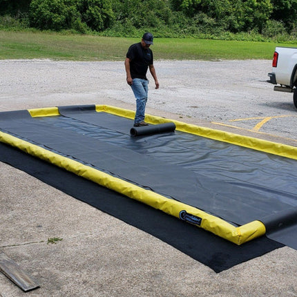 A man rolling out track guards on a ProFlex Foam Wall Berm