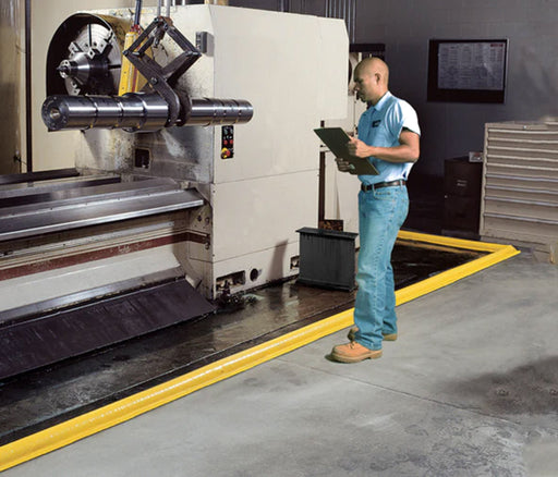 A man with a clipboard takes notes next to a Ultra-Build a berm