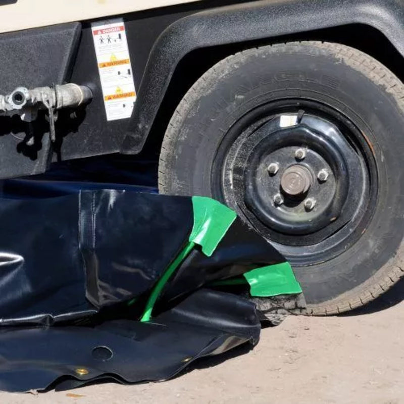 A truck drives over an Ultra-Containment Berm stake wall model with no stakes in it