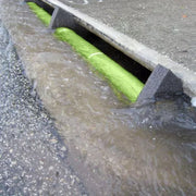 Water flows into a drain with an Ultra-Curb Guard Plus Model installed