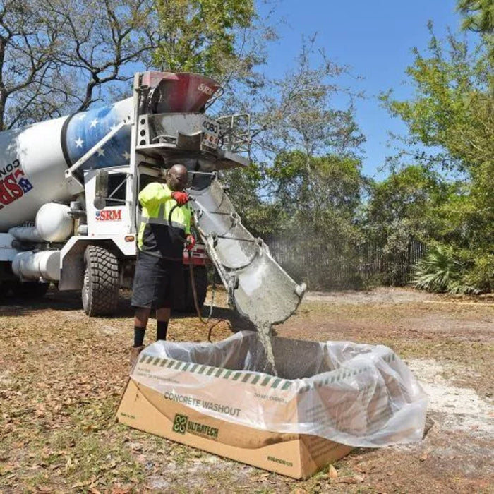 A concrete truck dumps concrete mix into an Ultra-Concrete Washout berm economy model